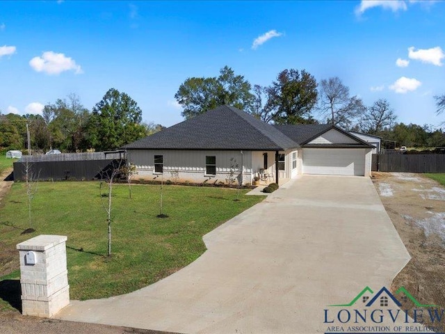 view of front of house featuring a garage and a front yard