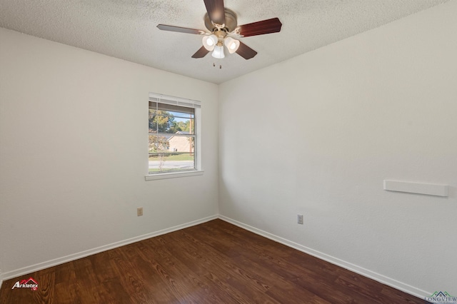 spare room featuring a textured ceiling, ceiling fan, and dark wood-type flooring