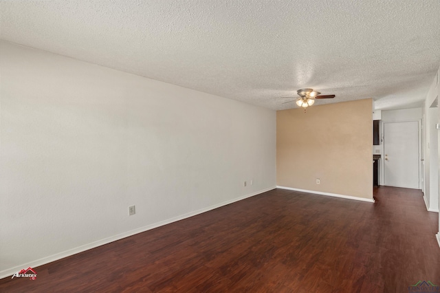 spare room featuring a textured ceiling, ceiling fan, and dark wood-type flooring