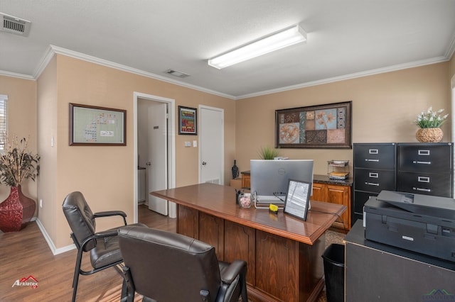 office featuring light wood-type flooring and crown molding