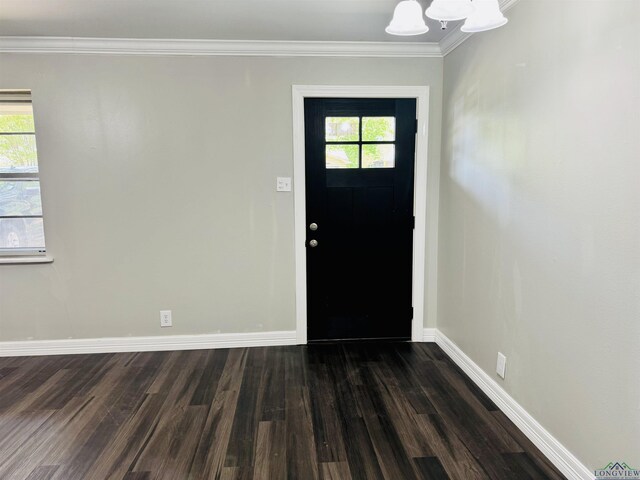 2317 Kaynell Dr, Henderson, TX 75654 - foyer entrance with dark wood-type flooring, ornamental molding, baseboards, and a notable chandelier