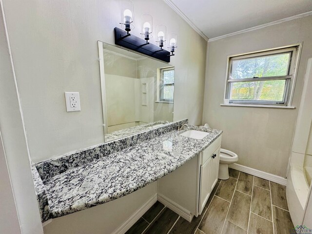 2317 Kaynell Dr, Henderson, TX 75654 - bathroom featuring toilet, a healthy amount of sunlight, ornamental molding, and wood tiled floor