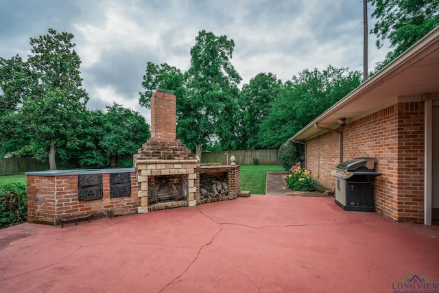 604 Woodcrest Ln, Longview, TX 75601 - fenced backyard with an outdoor stone fireplace, a patio, and a grill