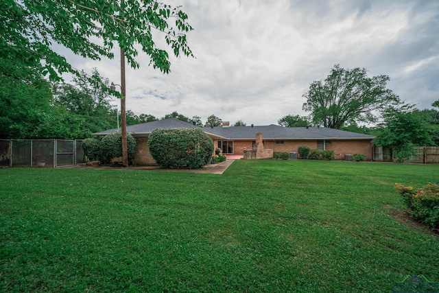 604 Woodcrest Ln, Longview, TX 75601 - rear view of property featuring brick siding and a chimney