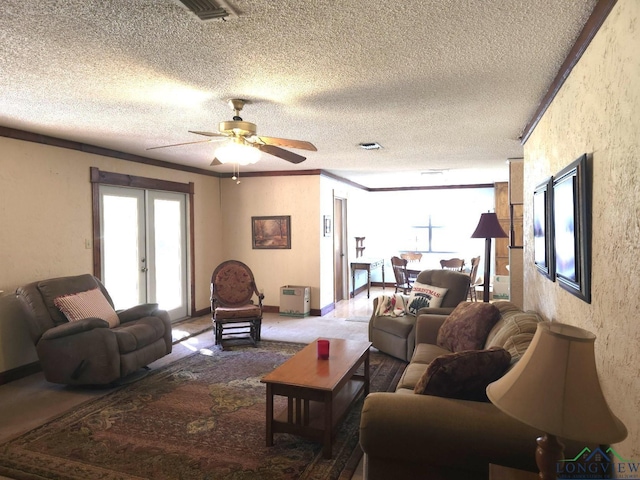 living room with french doors, ornamental molding, a textured ceiling, ceiling fan, and carpet floors