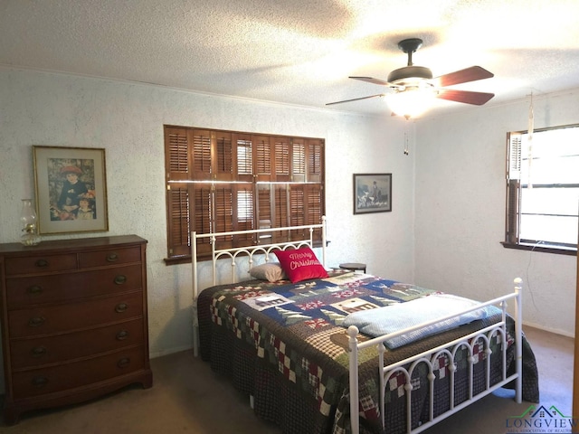 bedroom featuring carpet flooring, ceiling fan, a textured ceiling, and ornamental molding