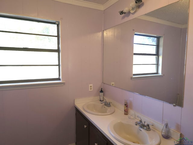 bathroom featuring a textured ceiling, vanity, and crown molding