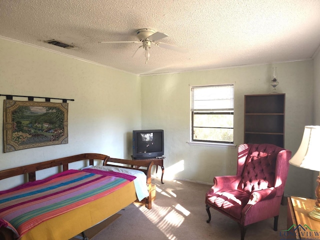 bedroom with carpet flooring, ceiling fan, and a textured ceiling