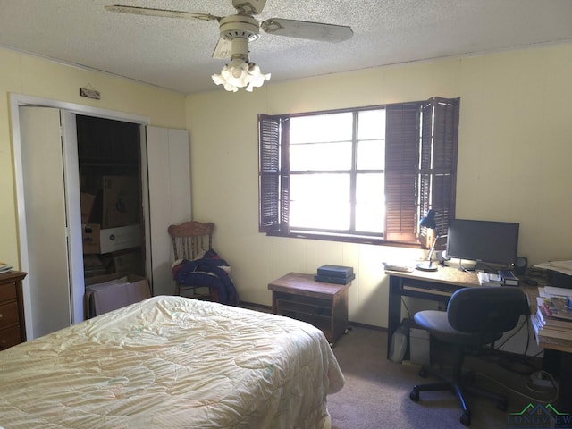 bedroom featuring light carpet, a textured ceiling, a closet, and ceiling fan