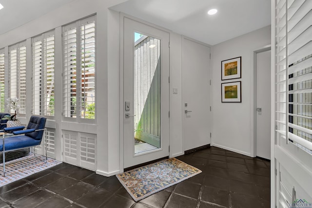 entrance foyer featuring a healthy amount of sunlight, tile patterned floors, baseboards, and recessed lighting