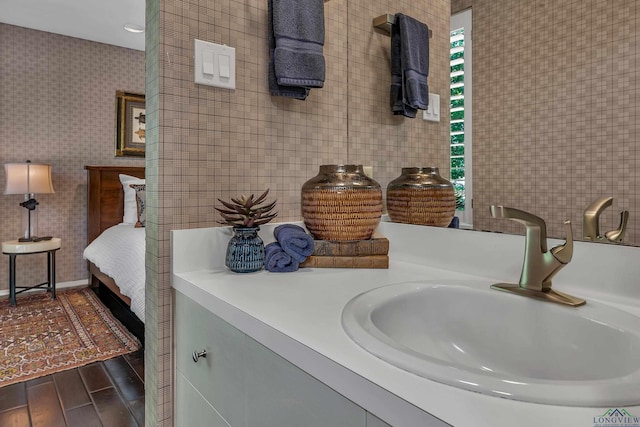 bathroom with tile walls, vanity, and wood finished floors