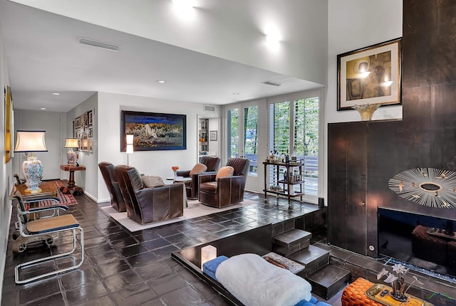 living area featuring baseboards, recessed lighting, and visible vents