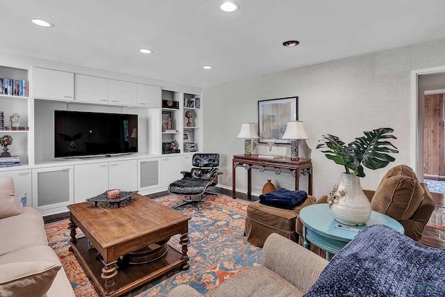 living area with built in features and recessed lighting