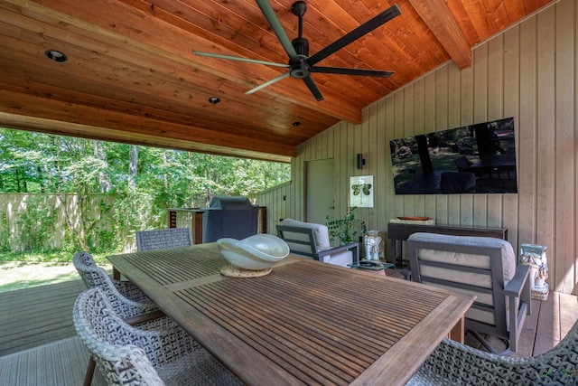 wooden terrace with a ceiling fan, grilling area, and outdoor dining space