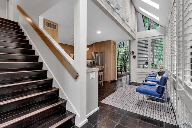 stairway featuring baseboards, stone finish flooring, recessed lighting, and visible vents