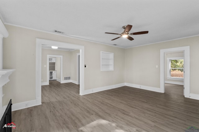 unfurnished living room with ceiling fan, built in features, ornamental molding, and dark wood-type flooring