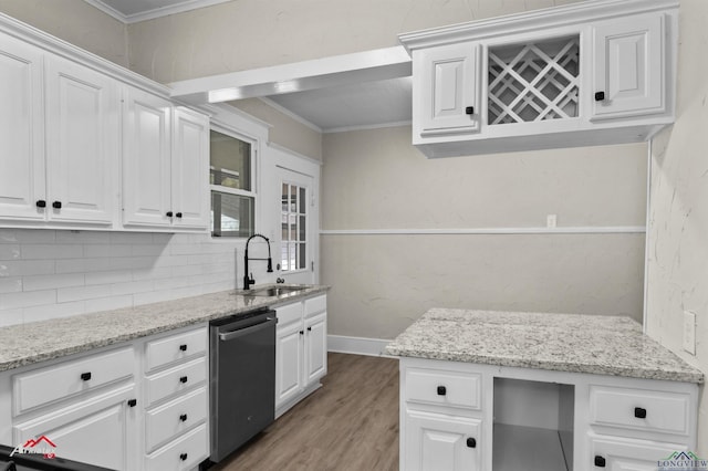 kitchen with dishwasher, crown molding, white cabinetry, and sink