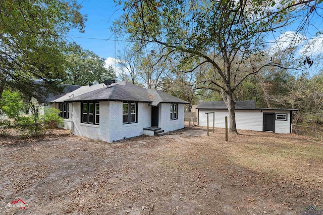 view of front of property with an outdoor structure