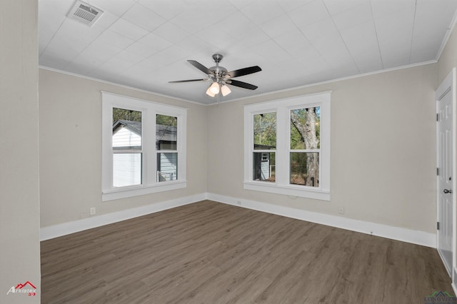 empty room with ceiling fan, dark hardwood / wood-style flooring, and ornamental molding