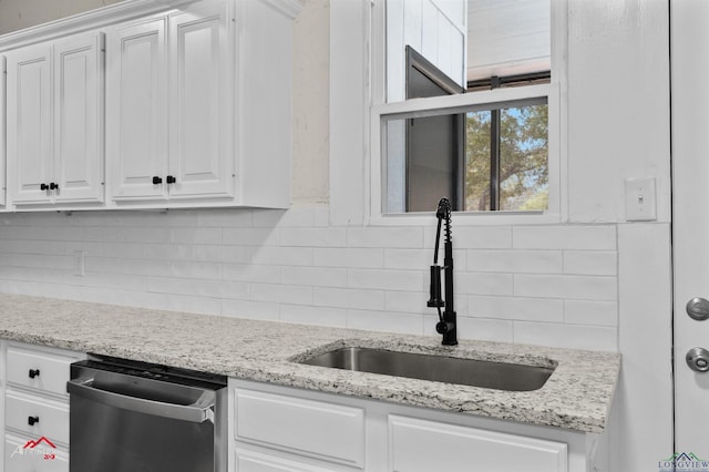 kitchen with white cabinets, decorative backsplash, dishwasher, and sink