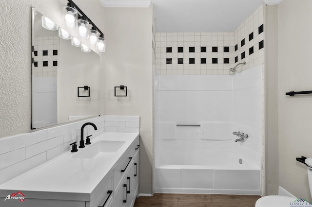 bathroom featuring washtub / shower combination, wood-type flooring, vanity, and tasteful backsplash