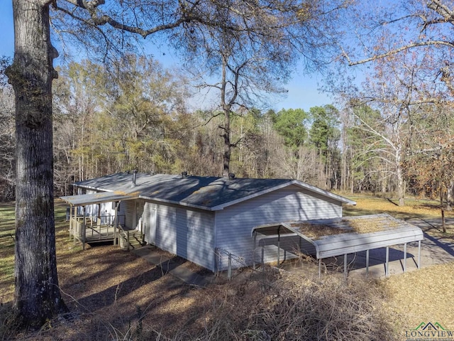 view of home's exterior featuring a carport