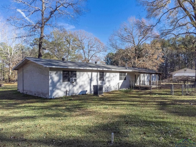 back of house with a lawn and central AC