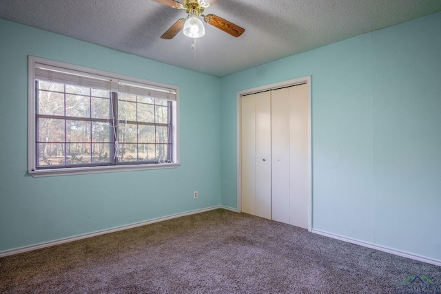 unfurnished bedroom with carpet flooring, a textured ceiling, a closet, and ceiling fan