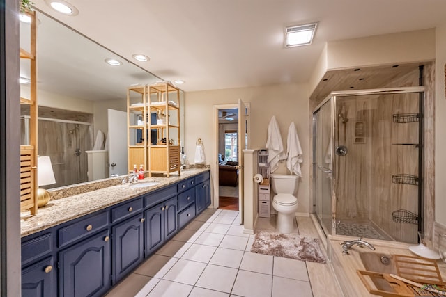 bathroom with toilet, tile patterned flooring, vanity, and walk in shower