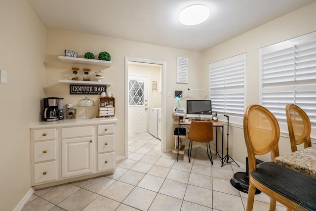 home office featuring light tile patterned floors and independent washer and dryer