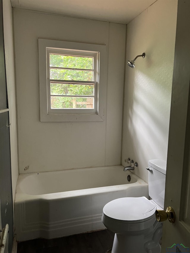 bathroom featuring a washtub and toilet