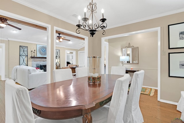 2713 Northridge Dr, Longview, TX 75605 - dining space with ceiling fan, light wood-type flooring, crown molding, baseboards, and a chandelier