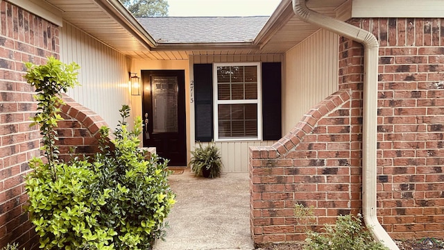 2713 Northridge Dr, Longview, TX 75605 - view of exterior entry with a shingled roof and brick siding