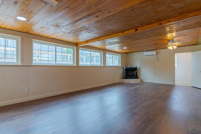 2713 Northridge Dr, Longview, TX 75605 - unfurnished living room with a wall mounted air conditioner, wood finished floors, wood ceiling, a ceiling fan, and a wood stove