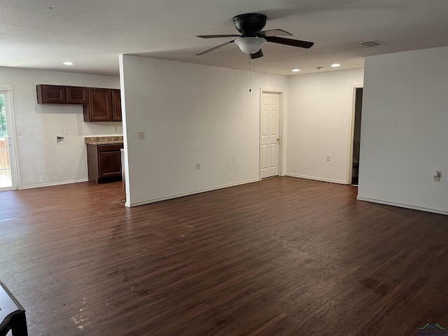 unfurnished living room with ceiling fan and dark hardwood / wood-style flooring