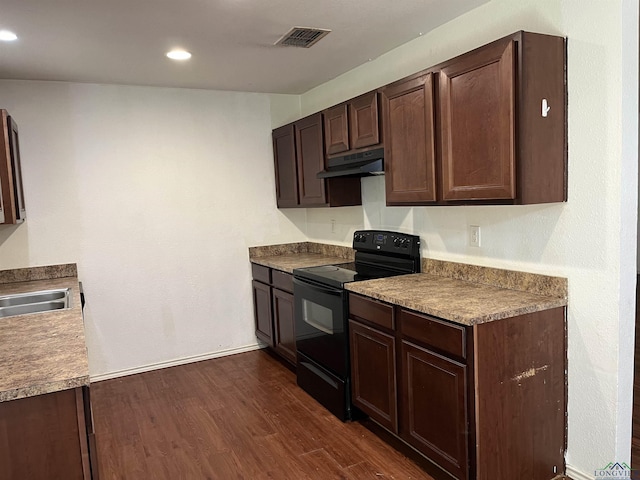 kitchen featuring black / electric stove, sink, dark brown cabinets, and dark hardwood / wood-style flooring