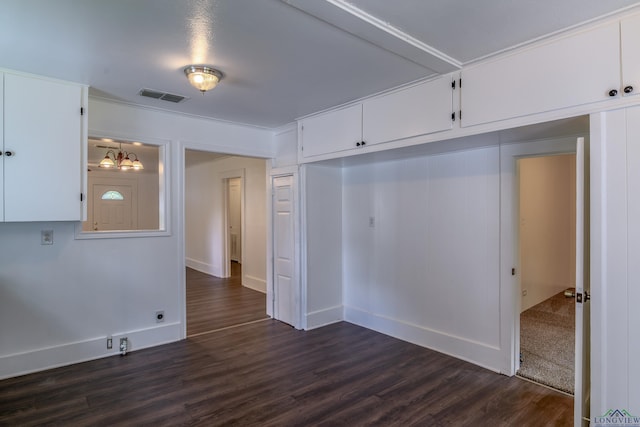 215 S Sidney St, Longview, TX 75602 - spare room with a chandelier and dark wood-style floors