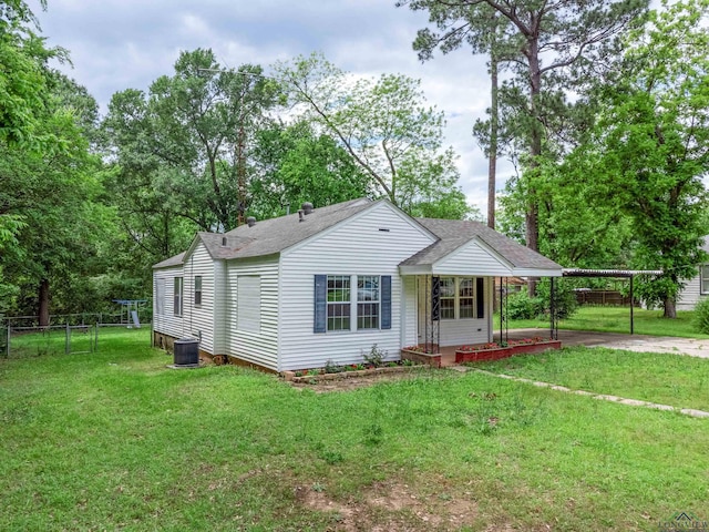 215 S Sidney St, Longview, TX 75602 - back of property featuring a shingled roof, a carport, and driveway