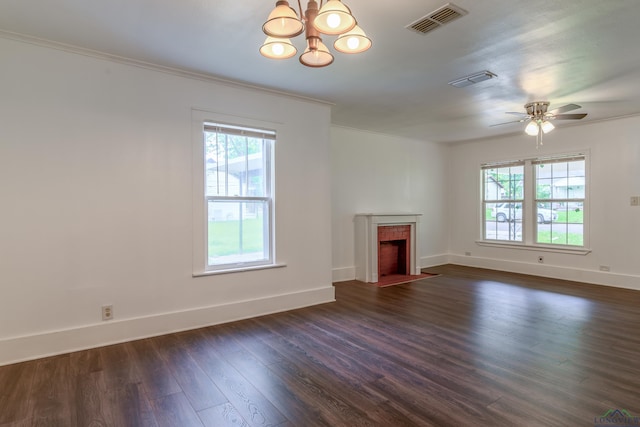 215 S Sidney St, Longview, TX 75602 - unfurnished living room with plenty of natural light, dark wood-style flooring, a chandelier, a fireplace with flush hearth, and ornamental molding