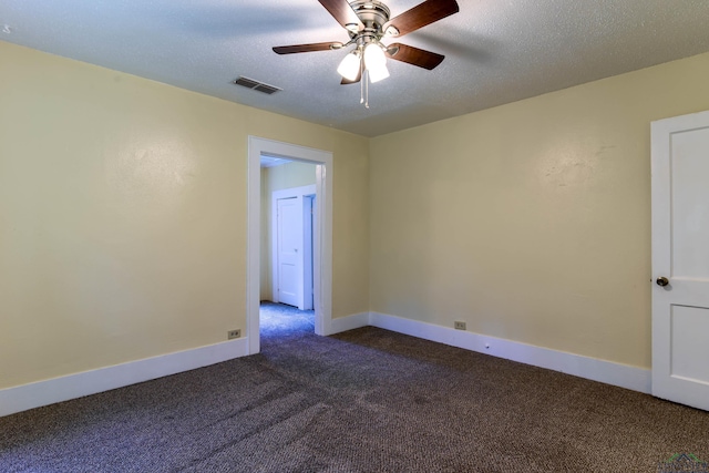 215 S Sidney St, Longview, TX 75602 - empty room featuring dark carpet, a ceiling fan, baseboards, and a textured ceiling