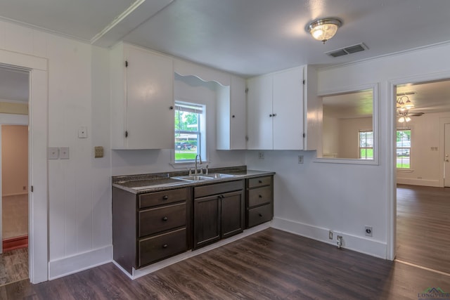 215 S Sidney St, Longview, TX 75602 - kitchen featuring a sink, dark wood-style floors, baseboards, white cabinetry, and ornamental molding