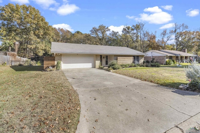 ranch-style house with a garage and a front yard