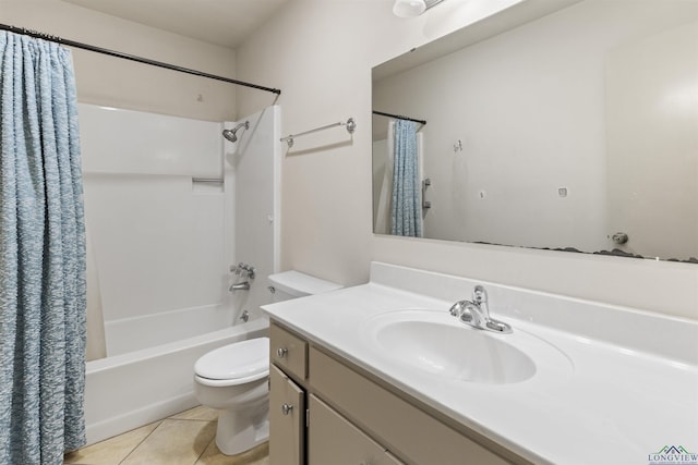 full bathroom with tile patterned floors, shower / bath combo with shower curtain, vanity, and toilet