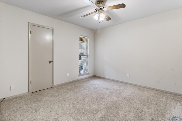 unfurnished room with ceiling fan and light carpet