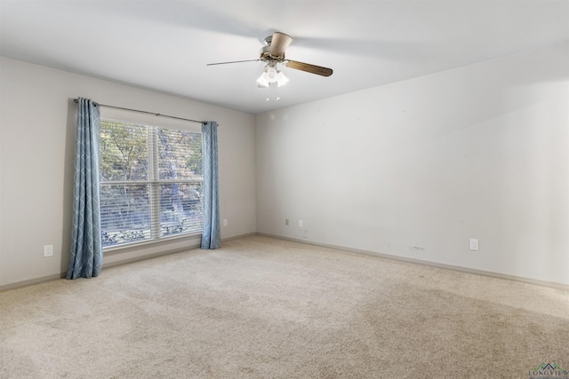 unfurnished room featuring ceiling fan and light colored carpet