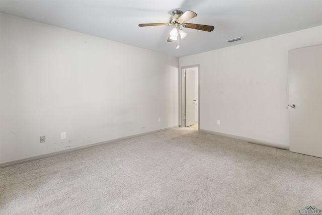 empty room with ceiling fan and light colored carpet