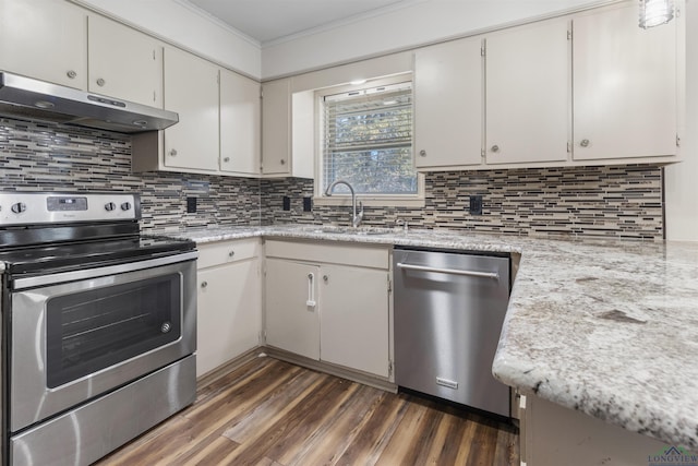 kitchen with white cabinets, backsplash, sink, and appliances with stainless steel finishes