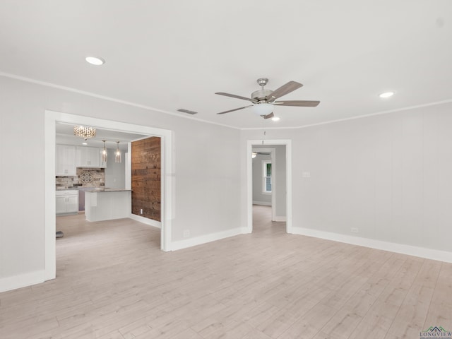 unfurnished room with a ceiling fan, ornamental molding, light wood-style floors, and visible vents