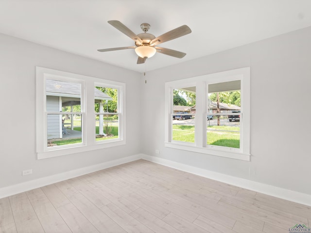 unfurnished room featuring baseboards, a ceiling fan, and light wood-type flooring