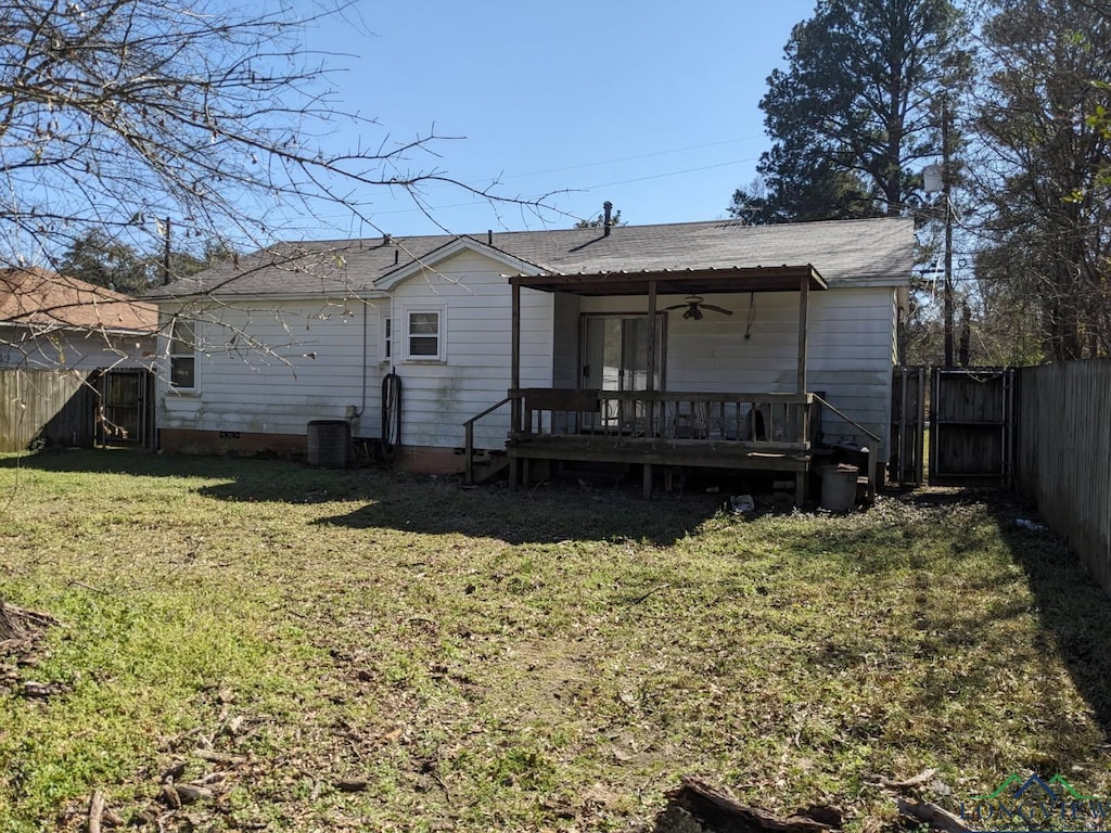 rear view of property featuring a yard, a ceiling fan, cooling unit, a fenced backyard, and a wooden deck